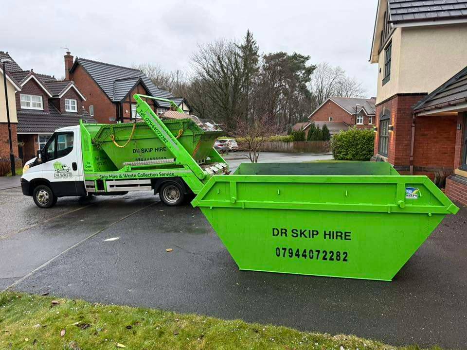 Aerial view of a North West town with a green waste collection lorry on the road